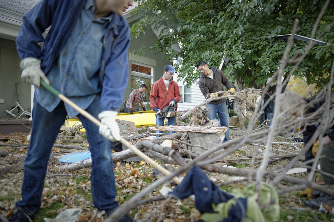Serving others by cleaning up tree limbs