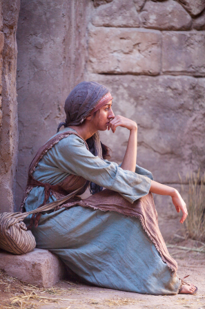 A woman sits and ponders the doctrines of the Savior