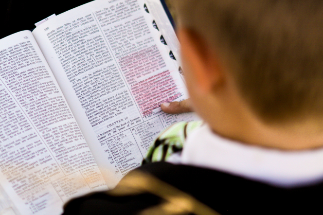 Boy reading the scriptures.