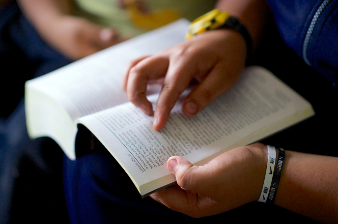 A young boy in Peru reads his scriptures.
