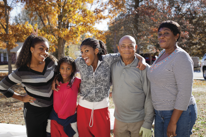 A mother, father and their three daughters enjoy family time. God's divine law of marriage is that it is between a man and a woman.